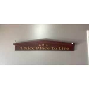 “A Nice Place to Live” Above Doorway Sign